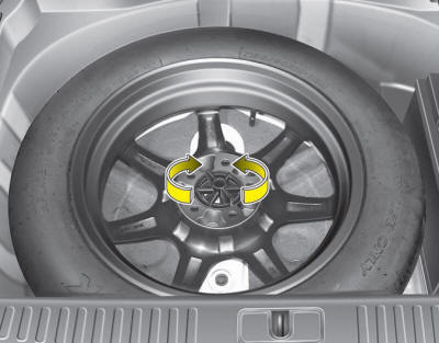 Turn the tire hold-down wing bolt counterclockwise.